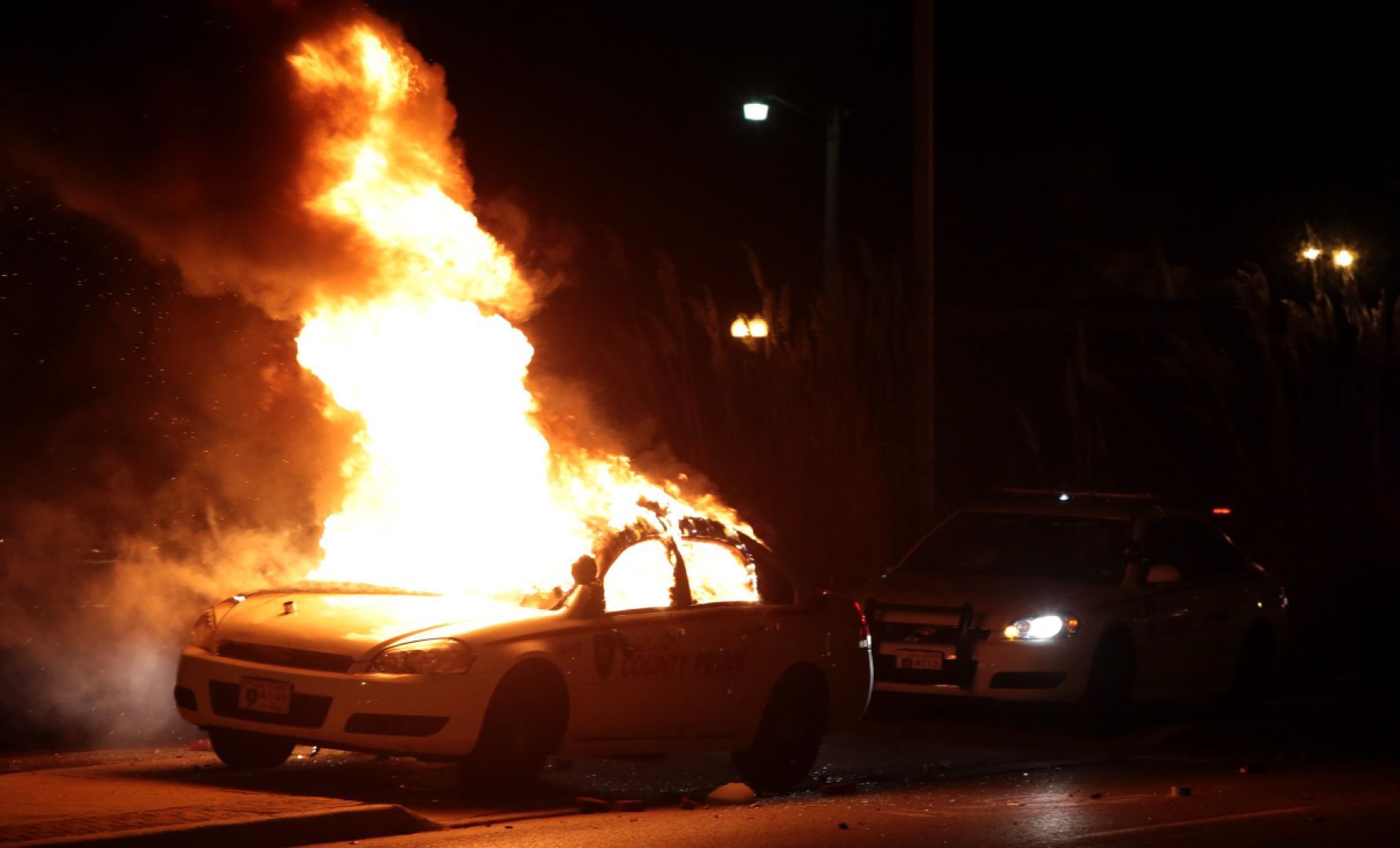 Protesters burn county police car in Ferguson after grand jury decision